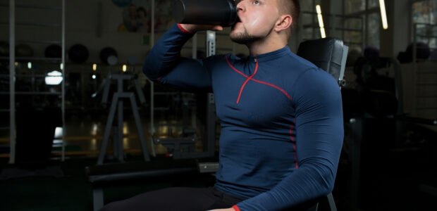 person drinking protein shake after workout