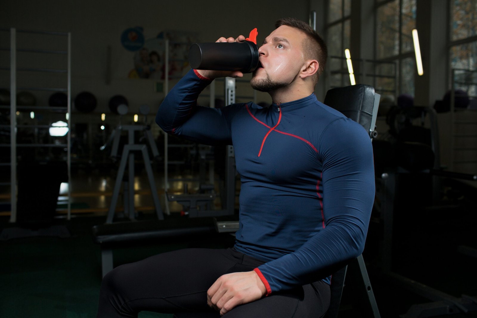 person drinking protein shake after workout